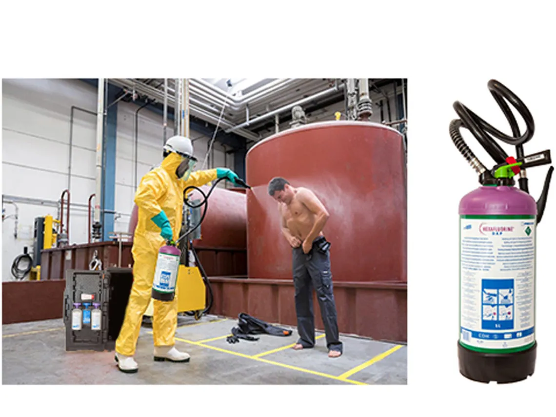 a person wearing a safety suit sprays hexafluorine on a victim of a chemical spraying accident